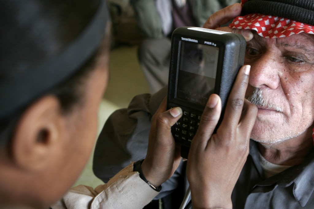 070110-M-8213R-024 U.S. Marine Corps Sgt. A.C. Wilson uses a retina scanner to positively identify a member of the Baghdaddi city council prior to a meeting with local tribal figureheads, sheiks, community leaders and U.S. service members deployed with Regimental Combat Team-7 in Baghdaddi, Iraq, on Jan. 10, 2007. Wilson is attached to the 4th Civil Affairs Group. DoD photo by Gunnery Sgt. Michael Q. Retana, U.S. Marine Corps. (Released)